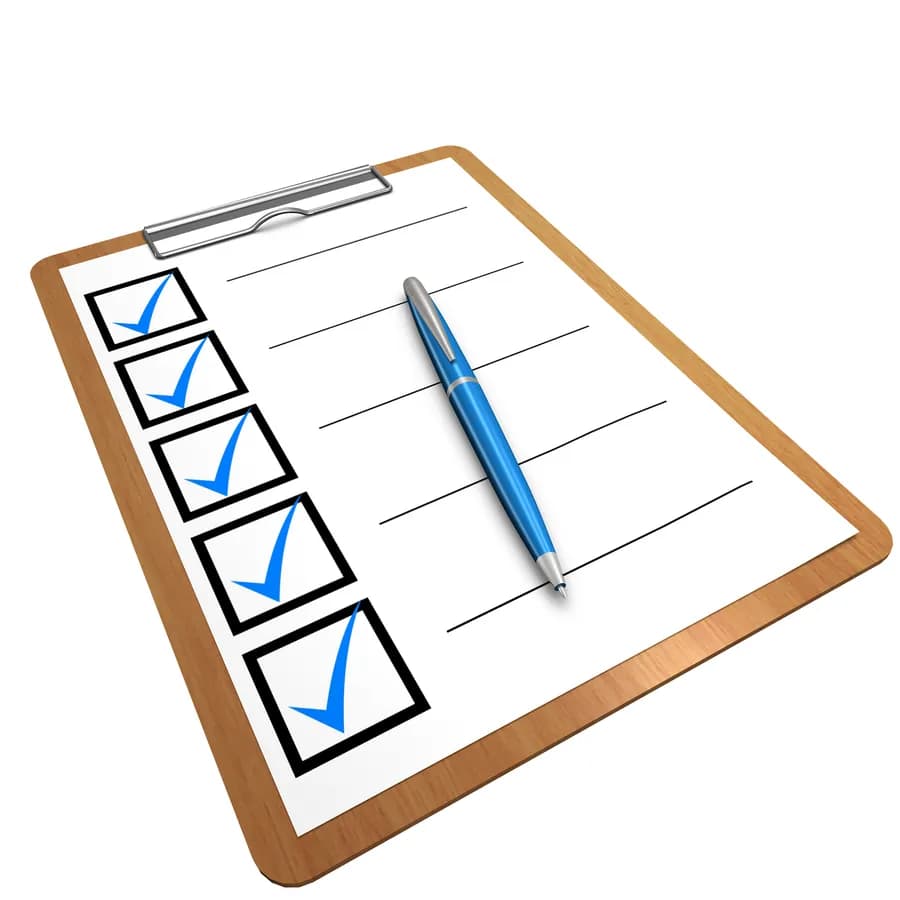 Clipboard with a completed checklist of blue tick marks and a pen