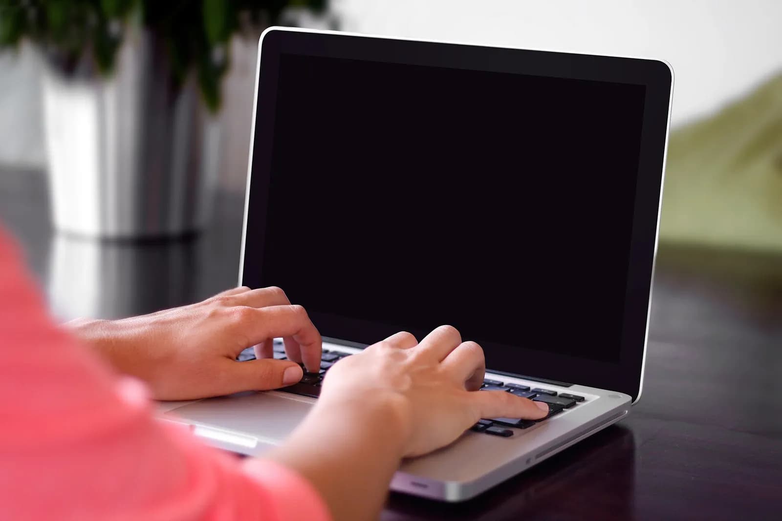 Person typing on a laptop at a desk
